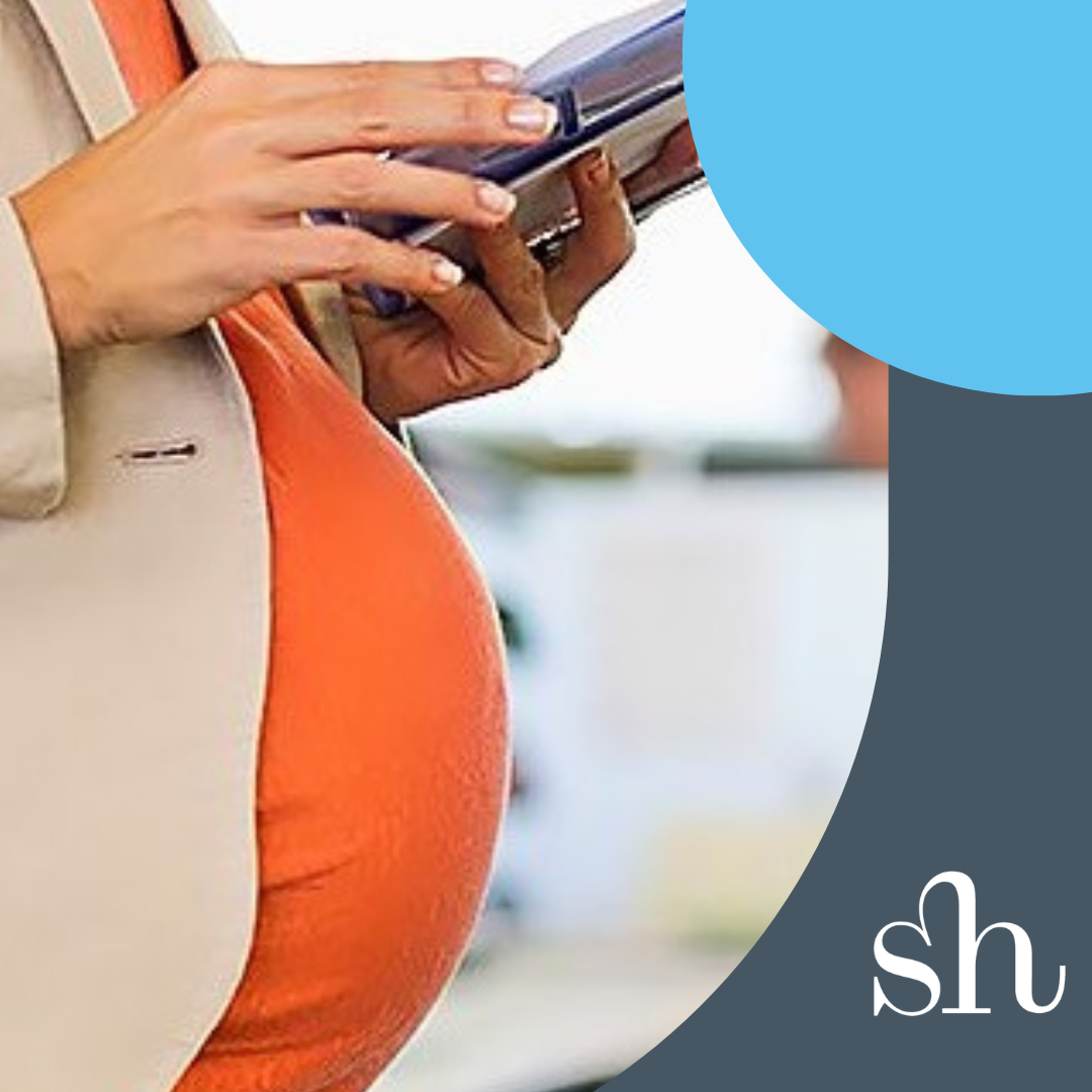 Pregnant person holding files