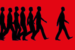 silhouettes of people walking with one figure breaking from the group