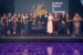 Group on individuals smartly dressed holding Scotland Women in Technology awards with a purple reflective floor 