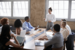 Decorative - senior leaders working around a boardroom.