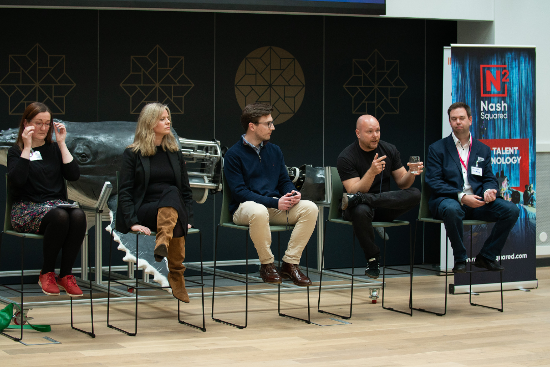 A photograph of the five panellists sitting on the stage at the National Robotarium.