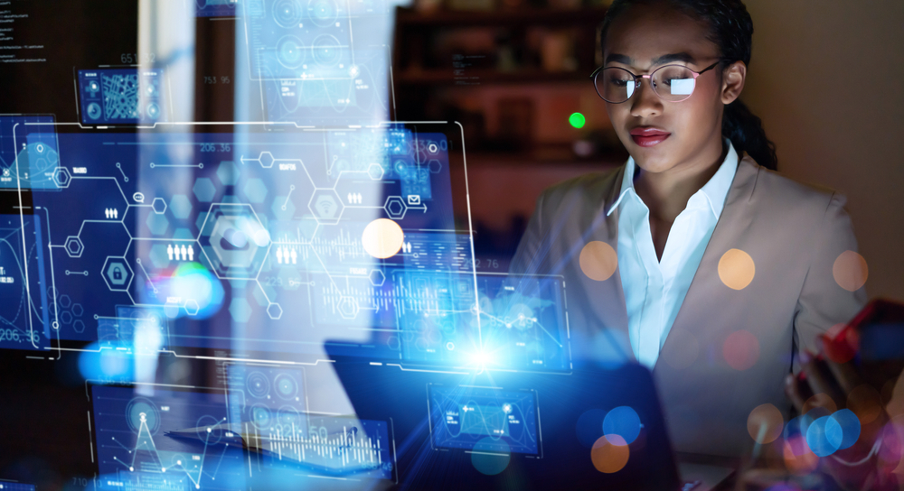 woman wearing shirt and blazer looking at laptop