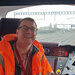 Garry in a railway signalling box wearing an orange jacket and smiling