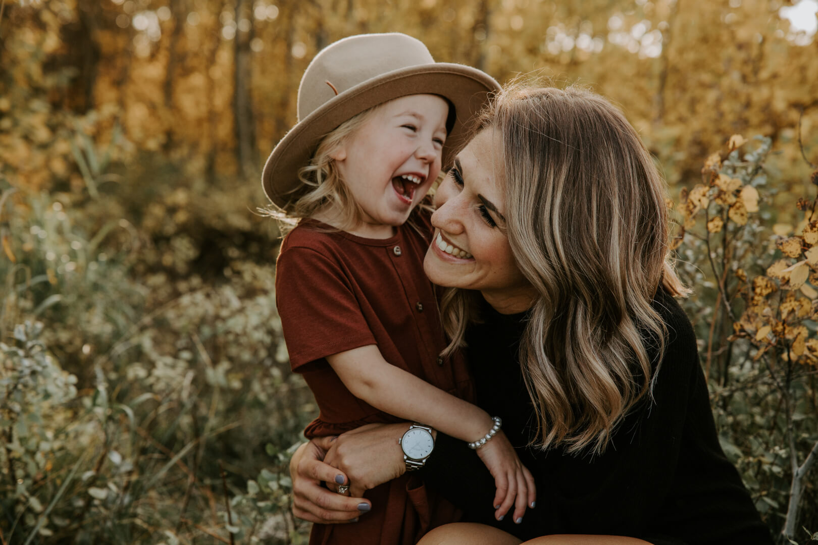 woman hugging a little girl and smiling