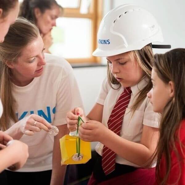 women teaching young children