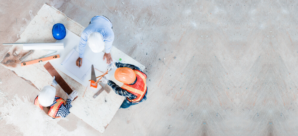 image of a team reviewing documents on a worksite 