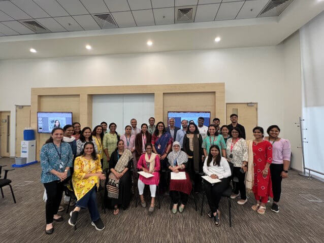 Image of employees posing for a picture after a fruitful discussion at office.