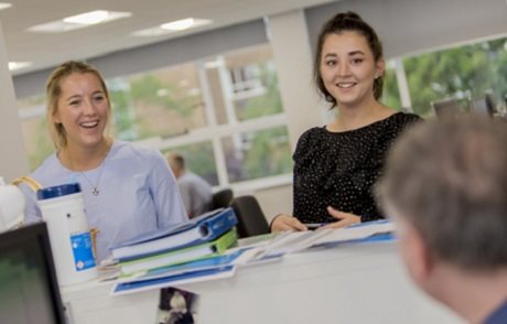 Image of Julie with her team in discussion