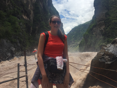 Photo of Jo standing next to a river.