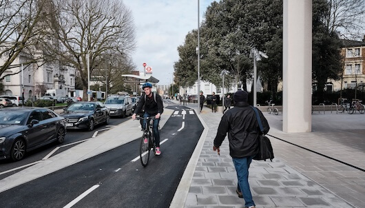 cyclist travelling down cycle lane of a road