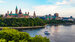 boat cruising on a river with Ottawa's skyline in the distance