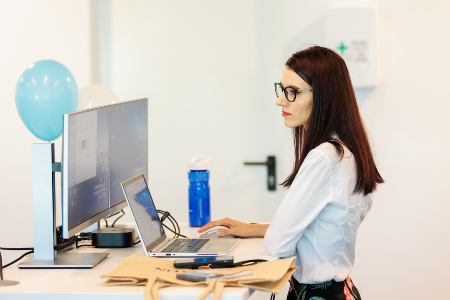 Picture of a woman standing and working in the office