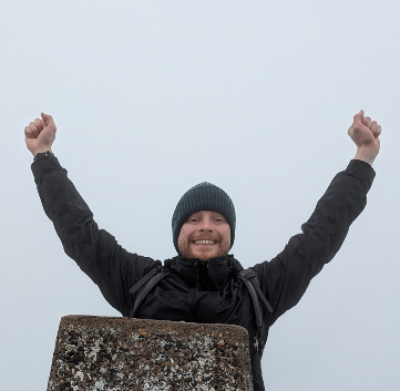 Photo of Dan on a cliff