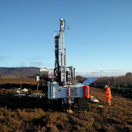 image of Michael next to a ground drill