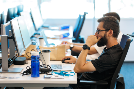 Photo of people working in their workstations