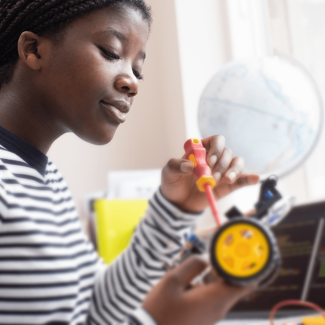 Image of woman working on a robotic car