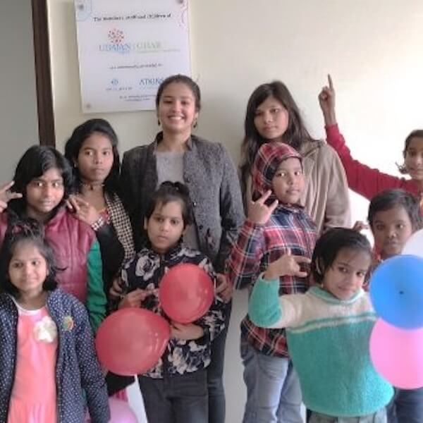 group of people in a classroom holding balloons