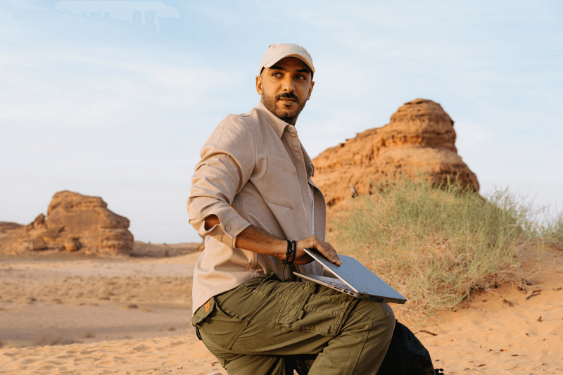 man in desert with laptop