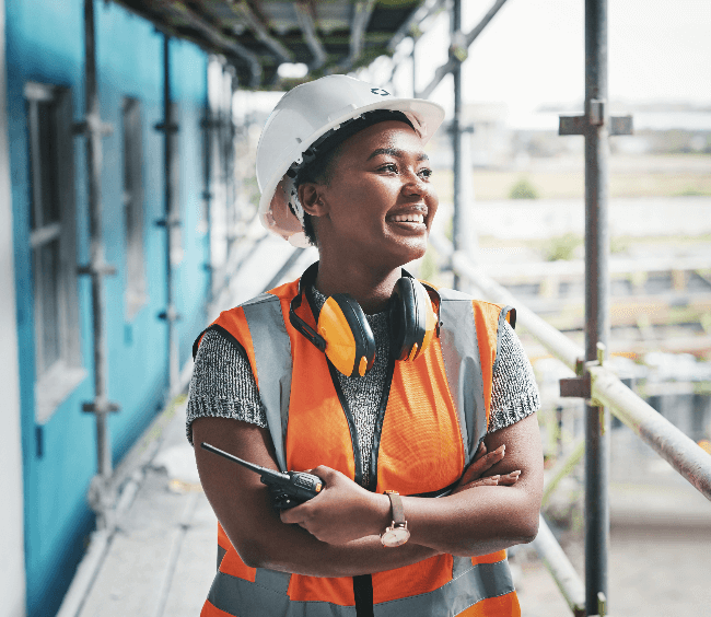 Image of a young woman smiling while wearing an Atkins hard hat