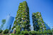 View of tall green buildings with overhanging balcony plants, emerging trends in civil engineering concept