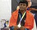 Ravi with Indian flag on his shoulders and holding his medal