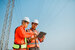 Electrical engineer and foreman checking plans in a tablet at at construction site