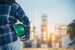 Woman engineer holding Green hard hats safety officer or inspector. Eco sustainable worker hands holding hardhat green work helmet Engineering.