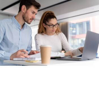 two people working at a laptop together