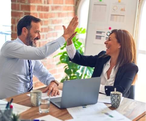 Image of man and woman high fiving each other