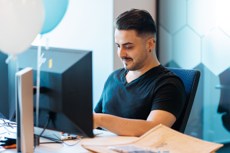 Photo of a man at his workstation