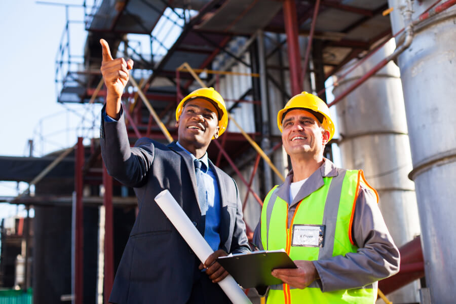 Two engineers on site pointing into the distance