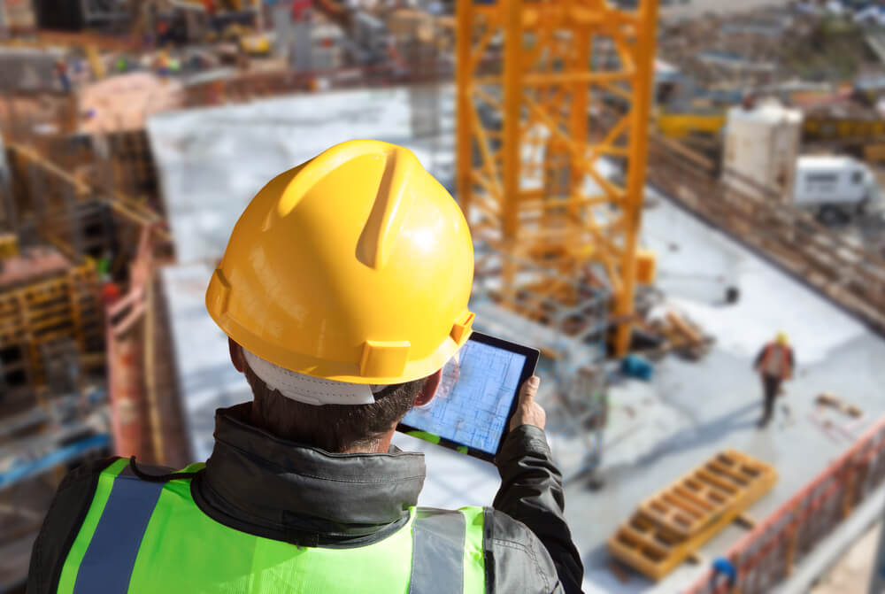 image of a lady looking at designs on a building site