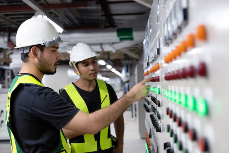 two male electric engineers on site