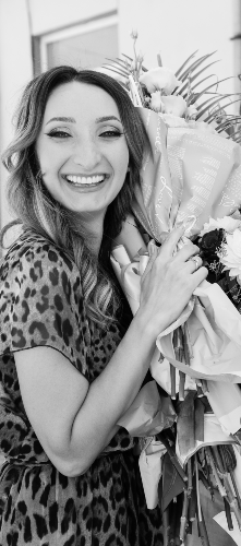 A happy picture of Alina holding a bouquet of flowers