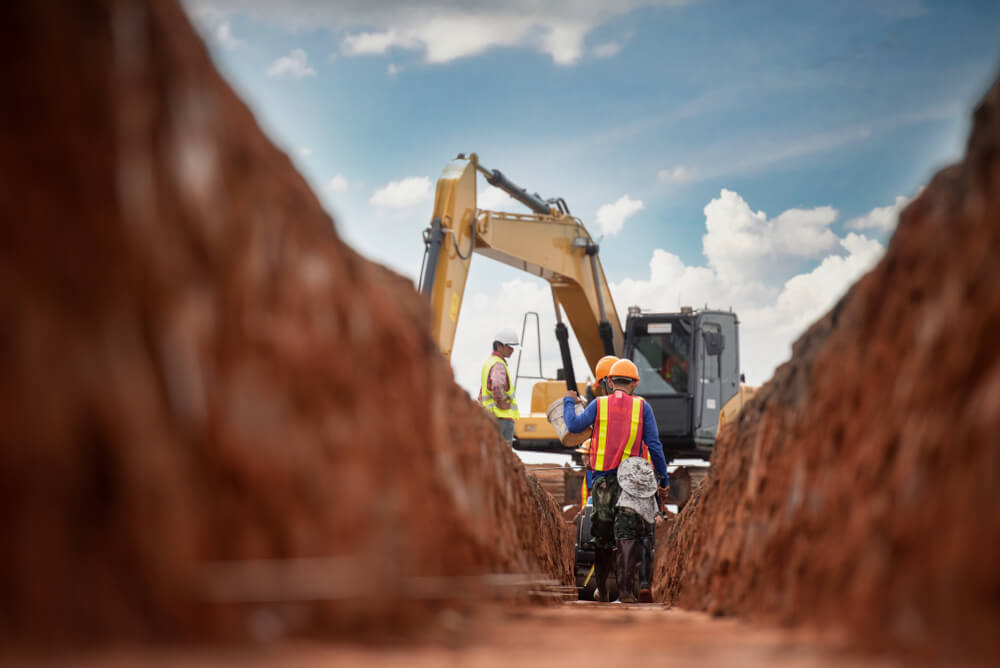 image of a team standing next to a digger