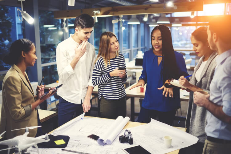 image of a team looking at notes