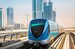 The dubai metro in motion with the city in the background