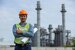 Portrait of asian worker power plant factory holding blueprint thumb up and smiling. 