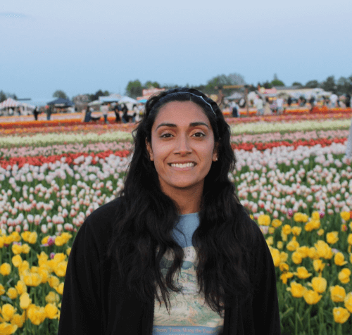 A smiling picture of Jasmine in the colourful tulip garden