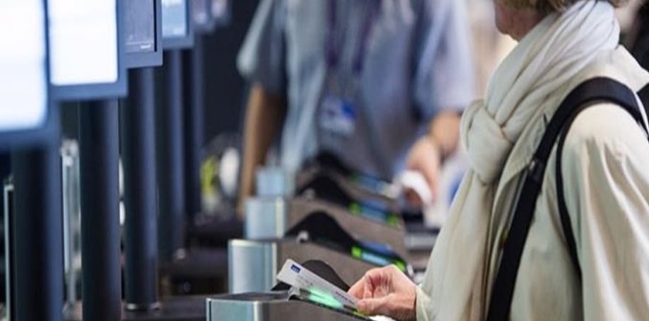 image of people scanning their boarding passes at the airport