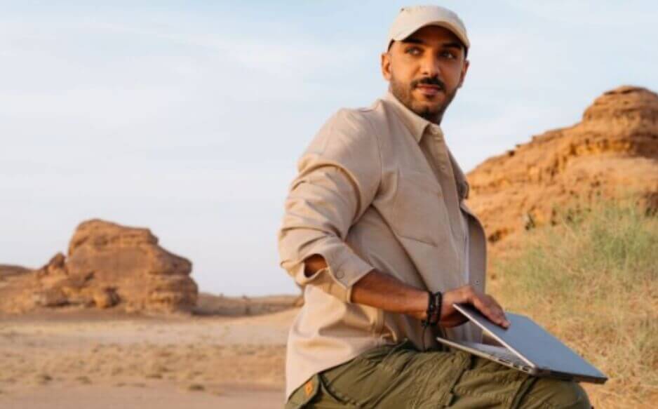 man in desert with laptop