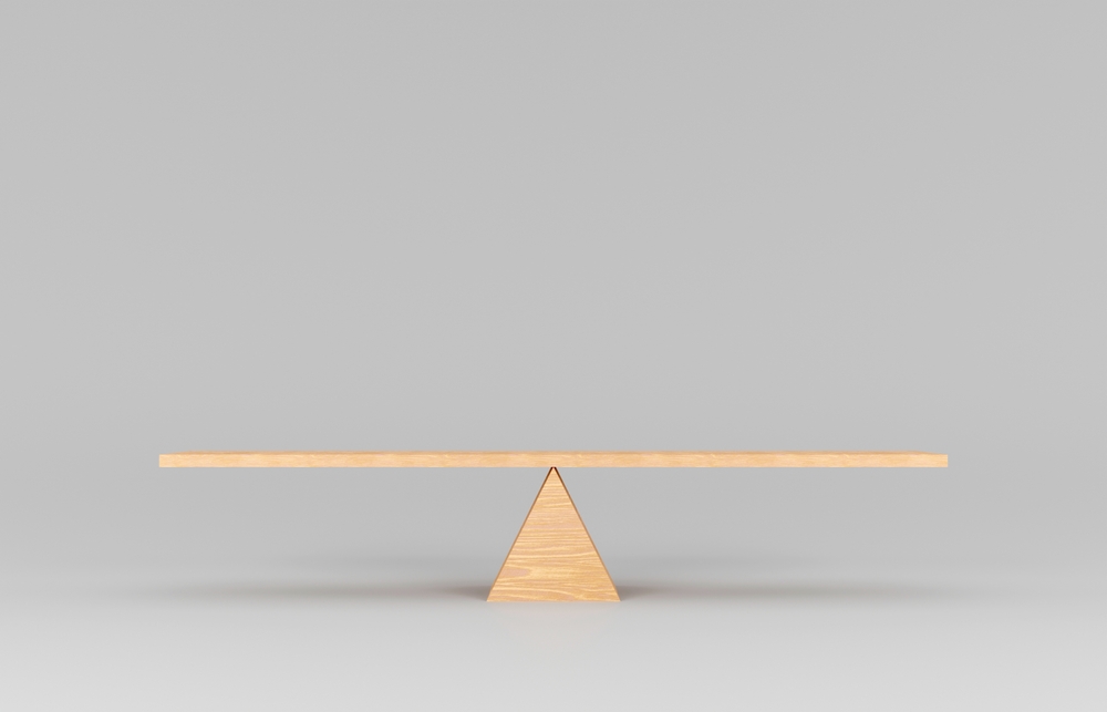 small wooden model of a seesaw