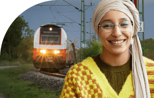 image of a woman smiling with a train in the background