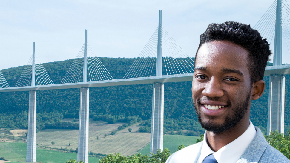 Black man in front of a brigde