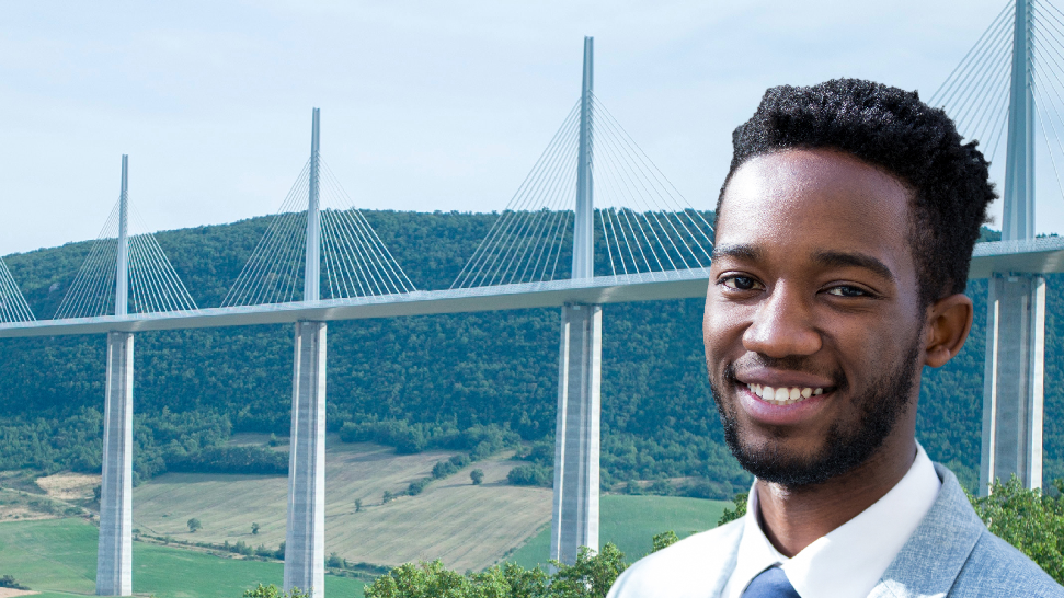 Man in front of a bridge