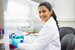 Closeup portrait, scientist holding 50 mL conical tube with blue liquid solution