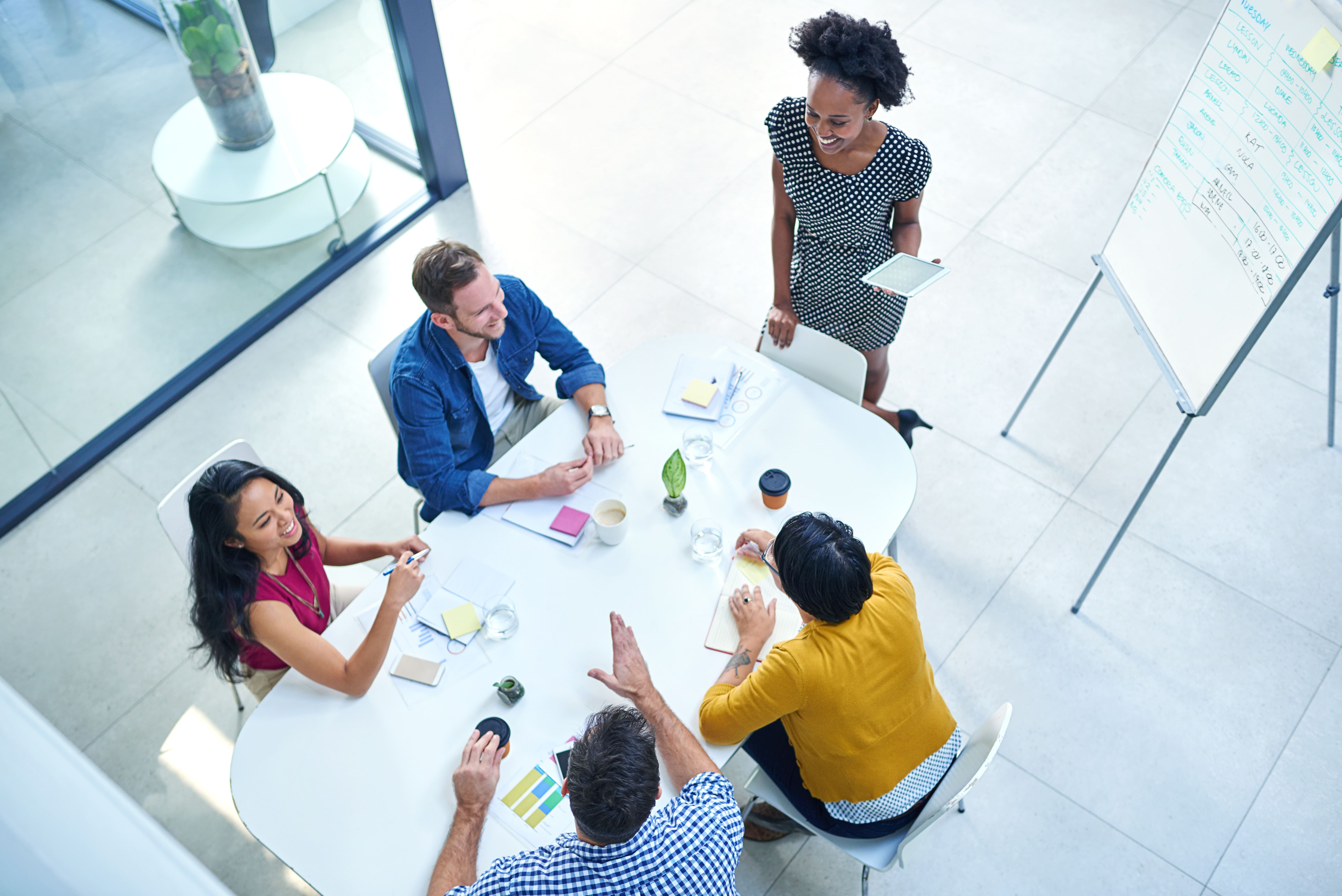 Above, presentation and creative business people in meeting for project management and planning schedule. Group, discussion and ideas for calendar for development, productivity or support of teamwork