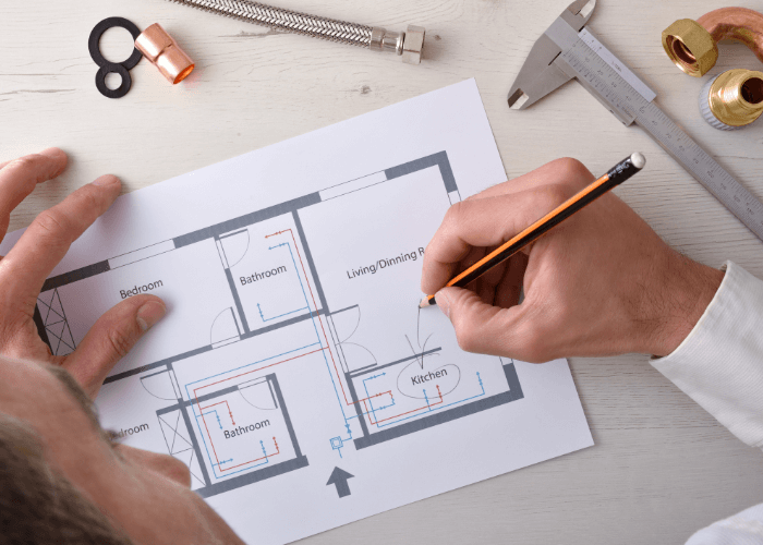 Piping designer with blueprints and tools