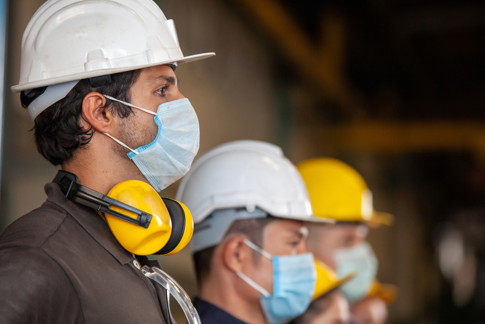 A man wearing a hard hat and safety gear