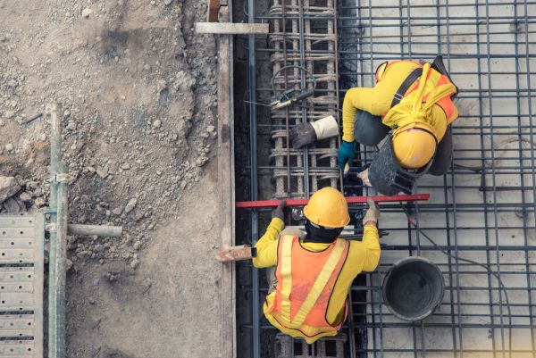 two people in protective equipment on a construction site